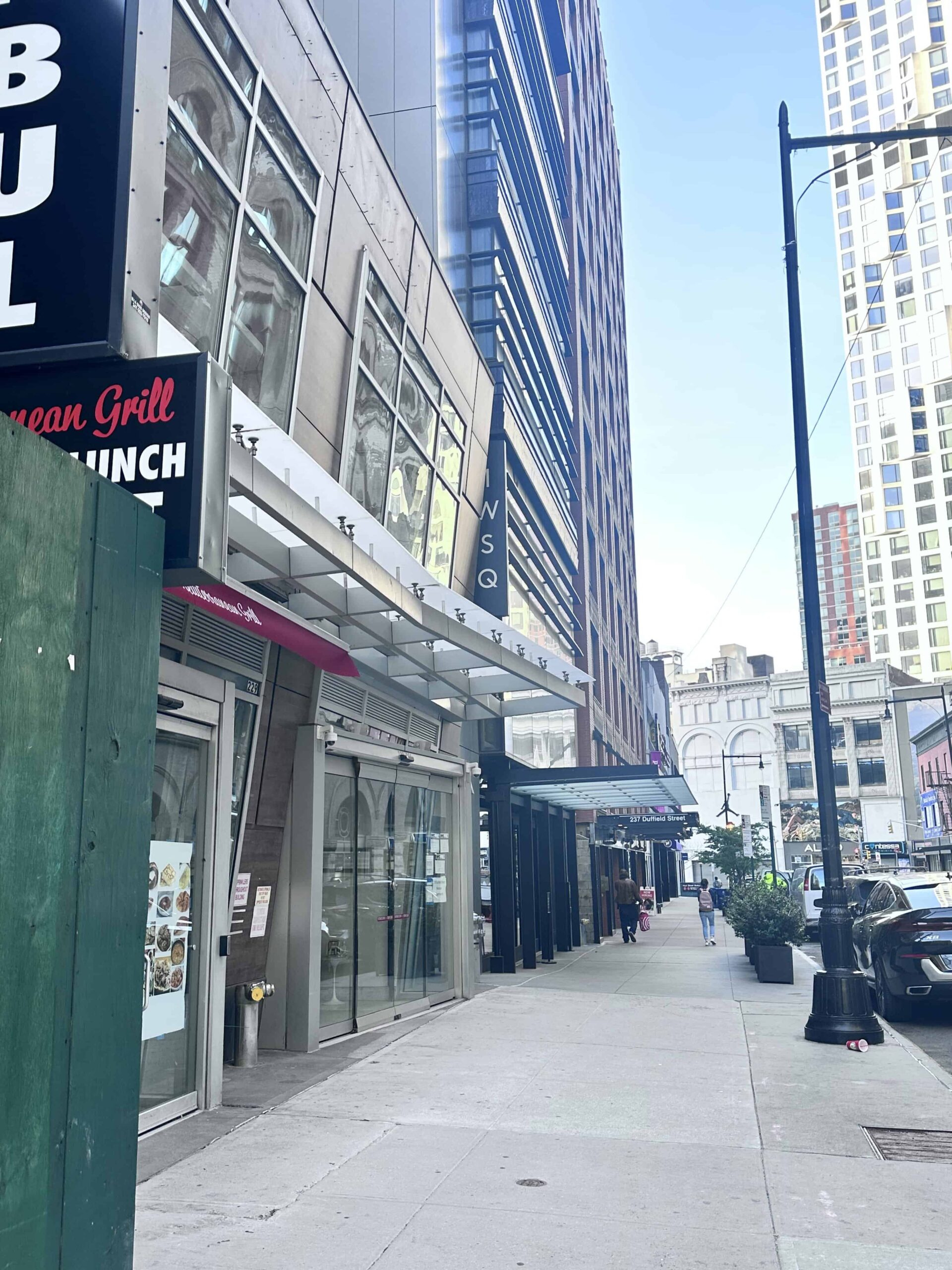 View of Duffield Street in Downtown Brooklyn, showcasing local businesses and pedestrian activity, with Webster Apartments located in the vibrant neighborhood.