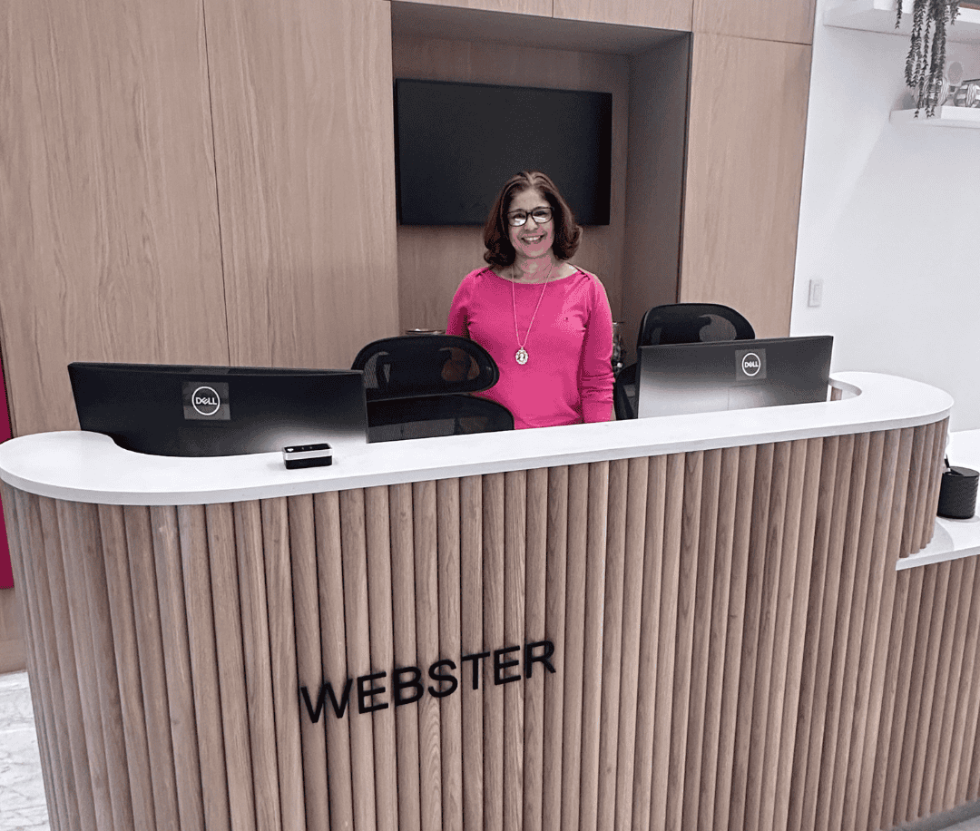 Front desk at Webster Apartments in Downtown Brooklyn with a welcoming staff member, offering a modern and stylish lobby for residents.