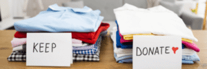 wo neatly folded piles of clothing on a table labeled 'Keep' and 'Donate,' representing a mindful approach to decluttering and spring cleaning.