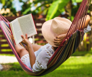 Woman reading book in hammock