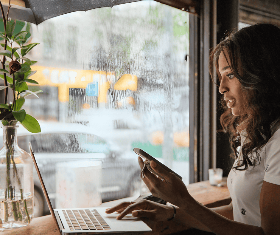 Businesswoman Working on Laptop in Cafe on Rainy Day