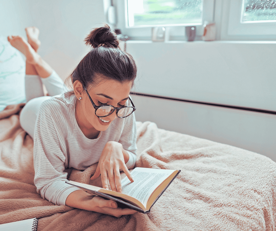 Woman reading book in bed