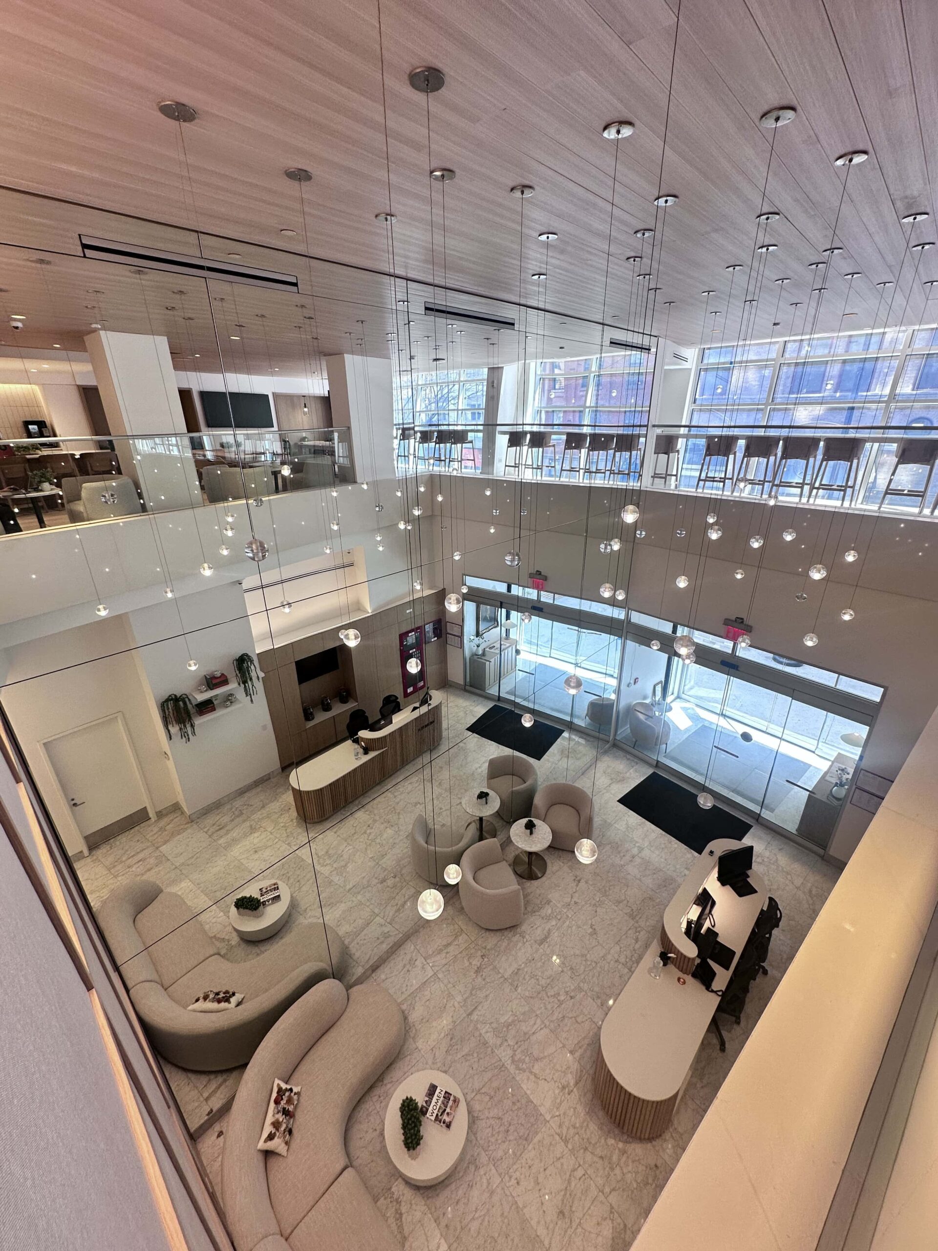 Aerial view of the modern, spacious lobby at Webster Apartments, featuring a stylish reception area, cozy seating, and sleek, contemporary design in Downtown Brooklyn.