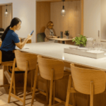 Residents enjoying the communal workspace and kitchen area at Webster Apartments in Downtown Brooklyn, designed for relaxation and productivity with modern amenities.